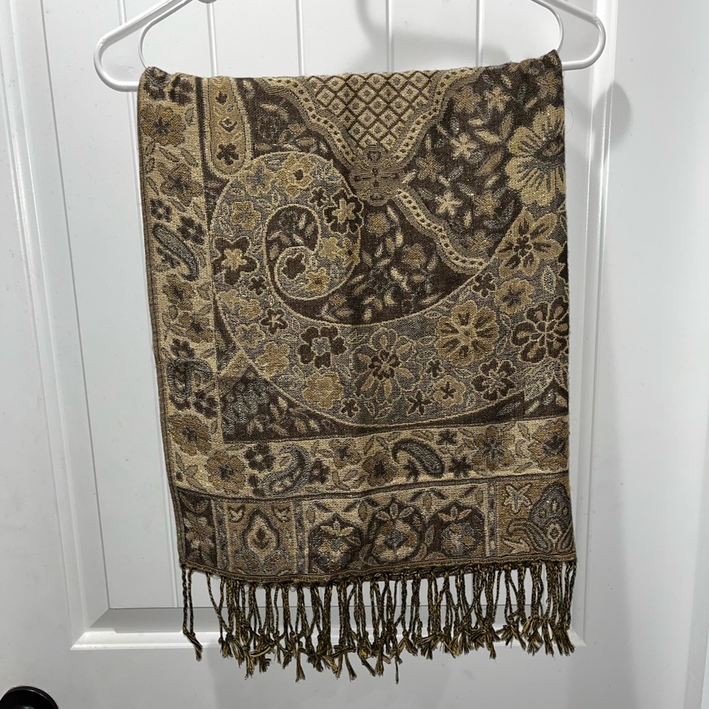 Beautiful gold and brown scarf. Fringe on the ends of the scarf.